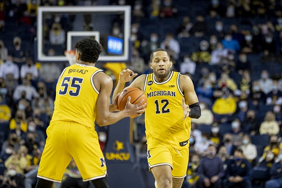 Eli Brooks (55) and DeVante' Jones (12)