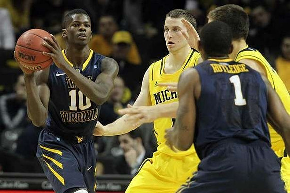 Nik Stauskas (11) and Mitch McGary (4)