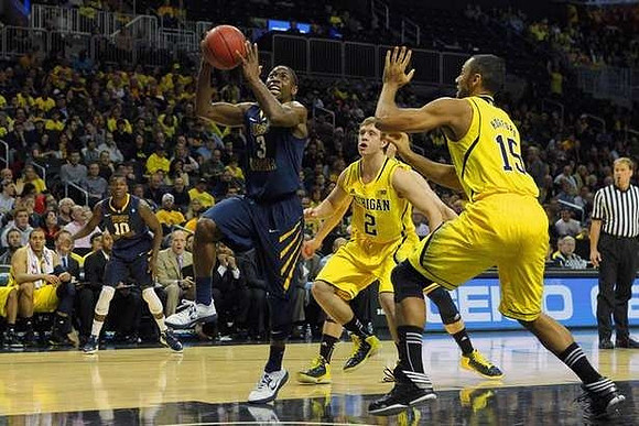 Spike Albrecht (2) and Jon Horford (15)
