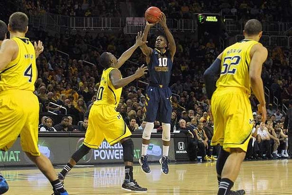 Mitch McGary (4), Tim Hardaway Jr. (10), and Jordan Morgan (52)