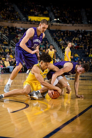 D.J. Wilson (5), Derrick Walton Jr. (10), and Mark Donnal (34)