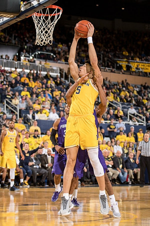 D.J. Wilson (5) and Zak Irvin (21)