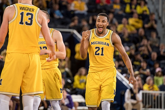 Zak Irvin (21), Moritz Wagner (13), and Duncan Robinson (22)