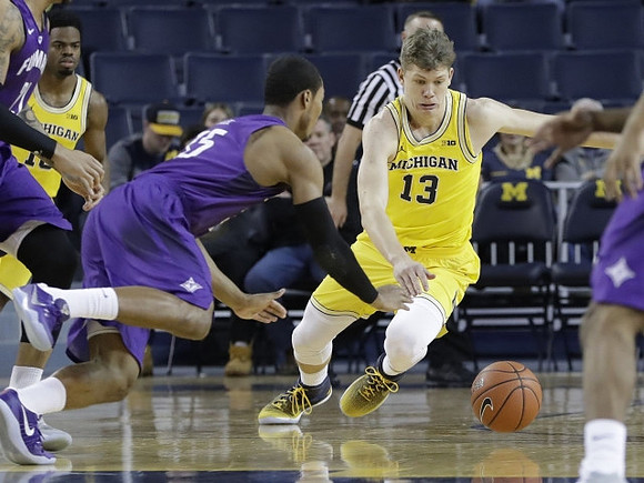 Derrick Walton Jr. (10) and Moritz Wagner (13)