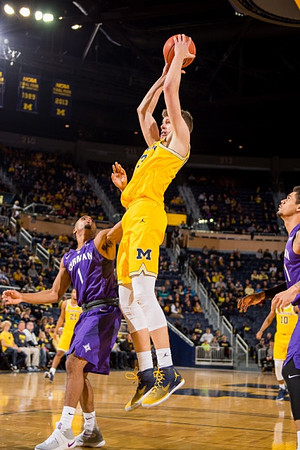 Moritz Wagner (13), Zak Irvin (21), and Derrick Walton Jr. (10)