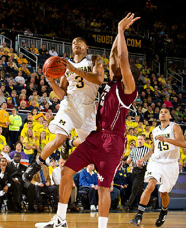 Trey Burke (3) and Colton Christian (45)