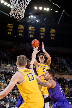 D.J. Wilson (5) and Moritz Wagner (13)