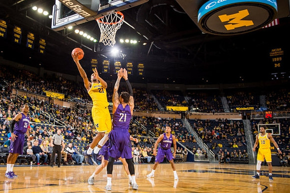 Zak Irvin (21) and Derrick Walton Jr. (10)
