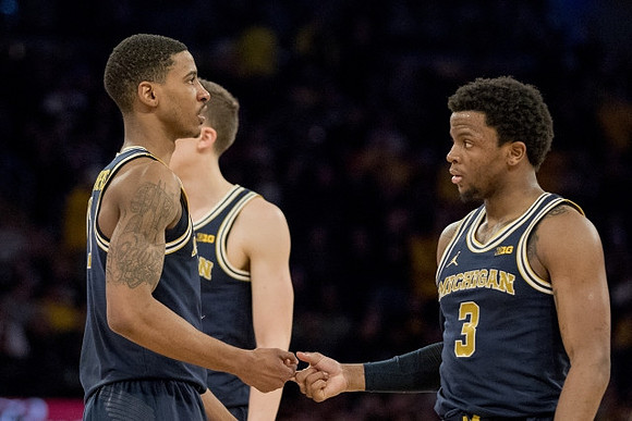 Charles Matthews (1), Duncan Robinson (22), and Zavier Simpson (3)