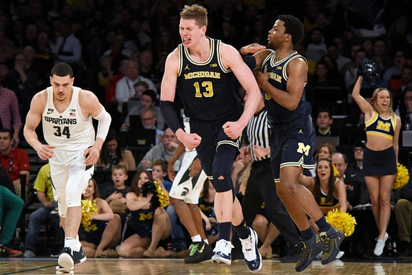 Moritz Wagner (13) and Zavier Simpson (3)