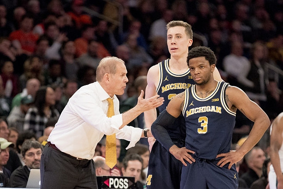 John Beilein, Duncan Robinson (22), and Zavier Simpson (3)