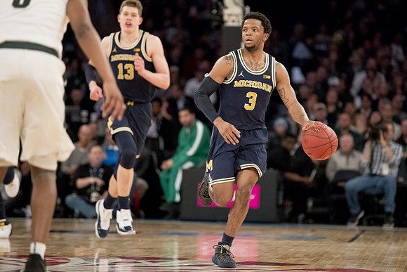 Moritz Wagner (13) and Zavier Simpson (3)