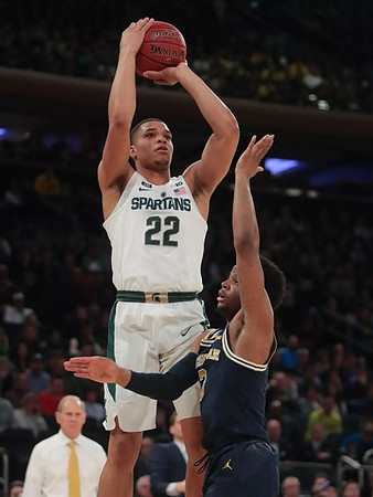 Zavier Simpson (3) and John Beilein