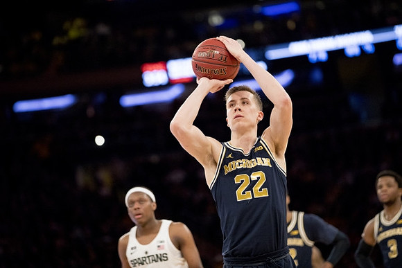 Duncan Robinson (22) and Zavier Simpson (3)