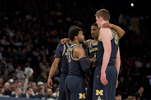 Muhammad-Ali Abdur-Rahkman (12), Zavier Simpson (3), Charles Matthews (1), and Jon Teske (15)