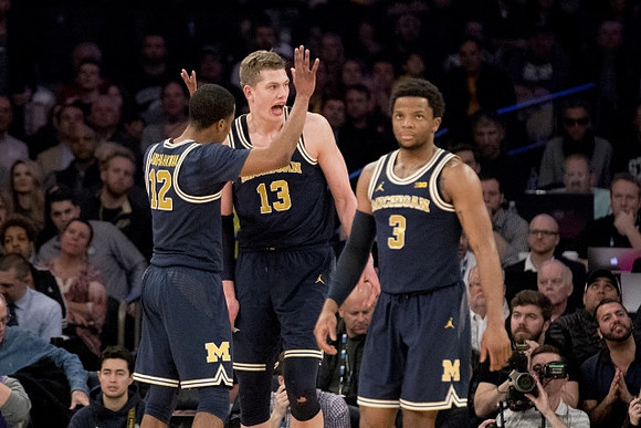 Muhammad-Ali Abdur-Rahkman (12), Moritz Wagner (13), and Zavier Simpson (3)