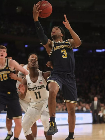 Jon Teske (15) and Zavier Simpson (3)