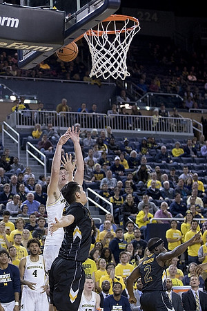 Isaiah Livers (4) and Jon Teske (15)