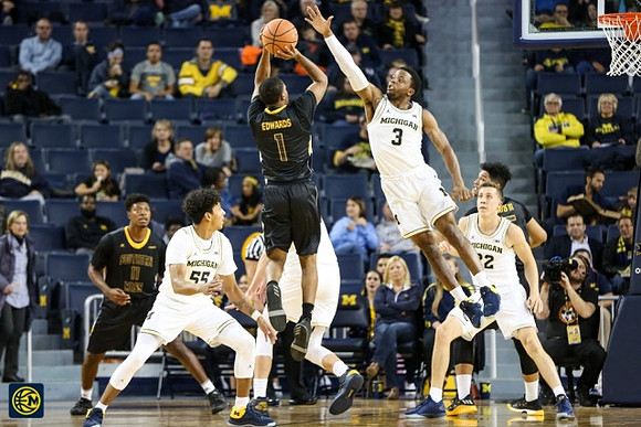 Eli Brooks (55), Zavier Simpson (3), and Duncan Robinson (22)