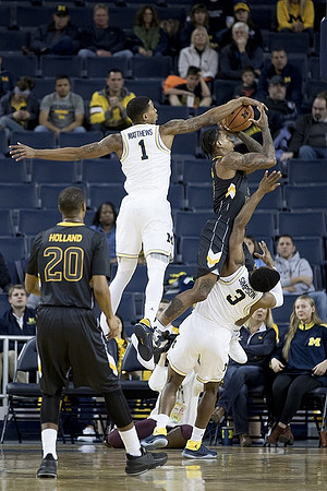 Charles Matthews (1) and Zavier Simpson (3)