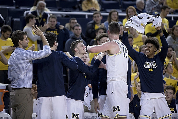 Jon Teske (15) and Michigan Team