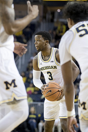 Zavier Simpson (3) and Eli Brooks (55)