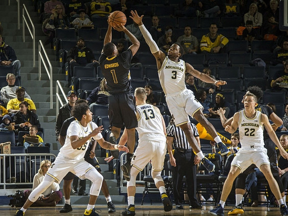 Eli Brooks (55), Moritz Wagner (13), Zavier Simpson (3), and Duncan Robinson (22)