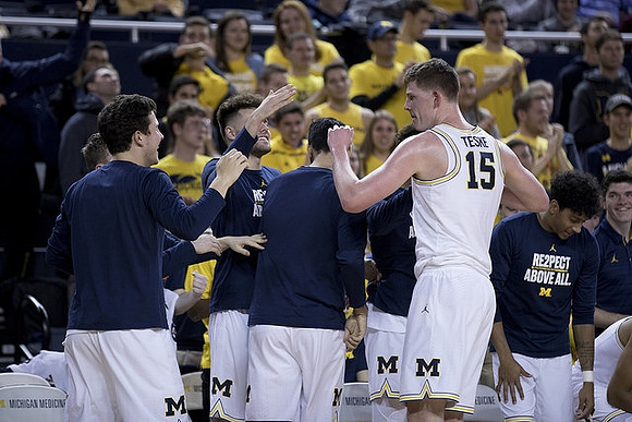 Jon Teske (15) and Michigan Team