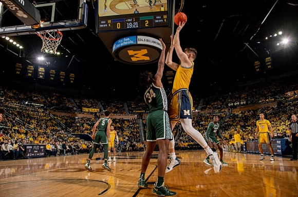 Hunter Dickinson (1), DeVante' Jones (12), and Caleb Houstan (22)