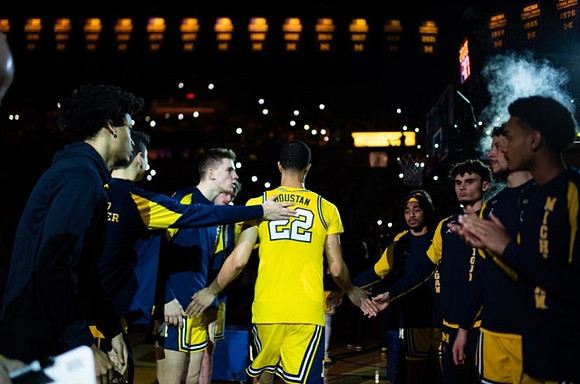 Caleb Houstan (22) and Michigan Team