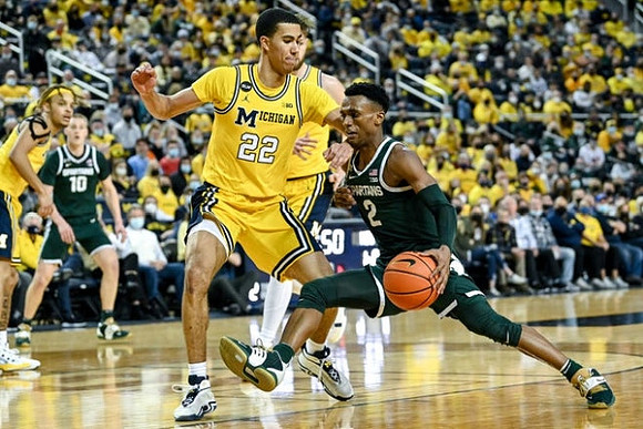 Caleb Houstan (22), Hunter Dickinson (1), and Terrance Williams II (5)