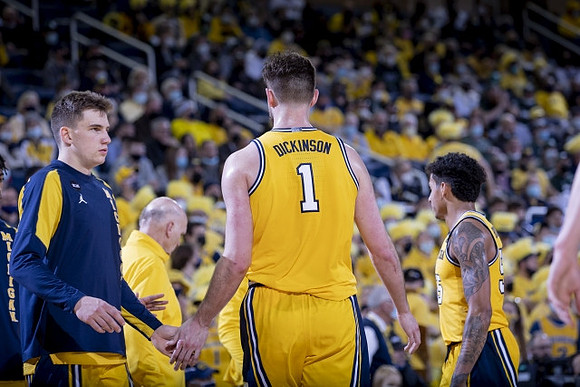 Hunter Dickinson (1), Phil Martelli, and Eli Brooks (55)
