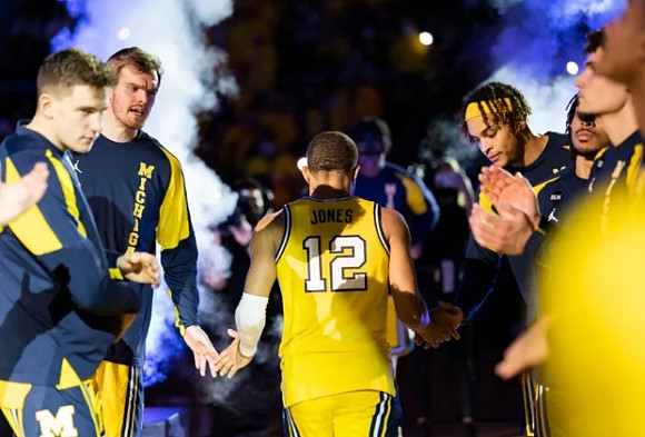 DeVante' Jones (12) and Michigan Team