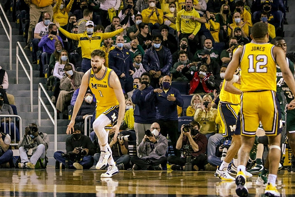 Hunter Dickinson (1) and DeVante' Jones (12)