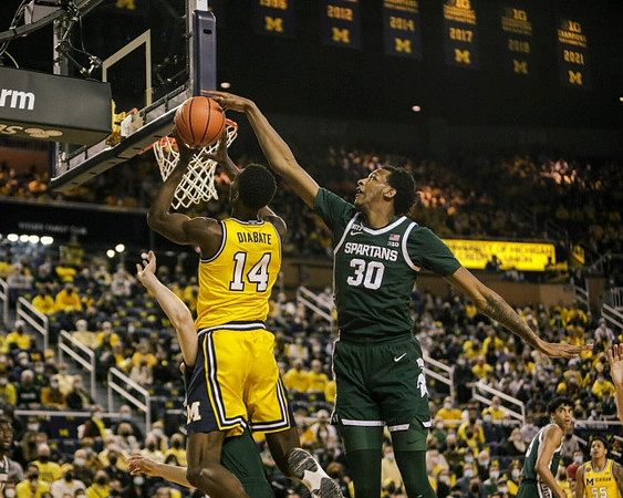 Moussa Diabate (14) and Eli Brooks (55)