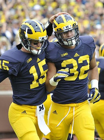 Jake Rudock (15) and Ty Isaac (32)