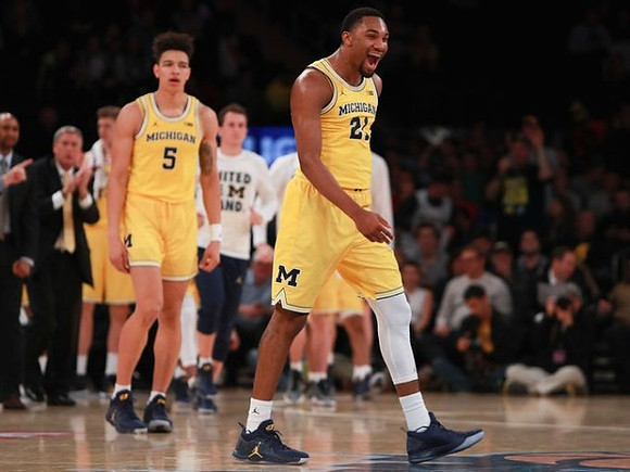 D.J. Wilson (5) and Zak Irvin (21)