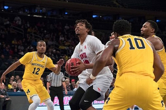 Muhammad-Ali Abdur-Rahkman (12), Derrick Walton Jr. (10), and Zak Irvin (21)