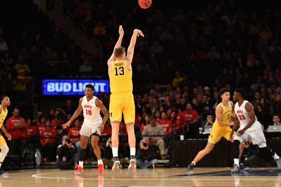 Zak Irvin (21), Moritz Wagner (13), and D.J. Wilson (5)