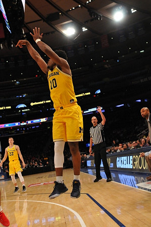 Duncan Robinson (22) and Derrick Walton Jr. (10)