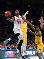 Mark Donnal (34) and Derrick Walton Jr. (10)