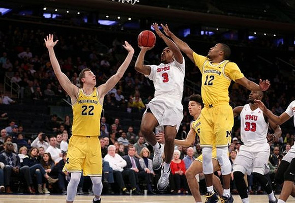 Duncan Robinson (22), D.J. Wilson (5), and Muhammad-Ali Abdur-Rahkman (12)