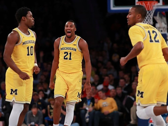 Derrick Walton Jr. (10), Zak Irvin (21), and Muhammad-Ali Abdur-Rahkman (12)