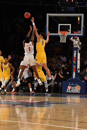 D.J. Wilson (5) and Zak Irvin (21)