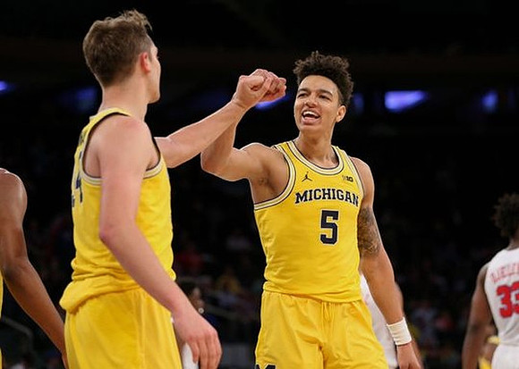 Mark Donnal (34) and D.J. Wilson (5)