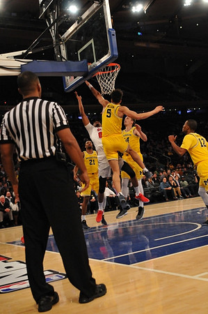 Zak Irvin (21), D.J. Wilson (5), Mark Donnal (34), and Muhammad-Ali Abdur-Rahkman (12)