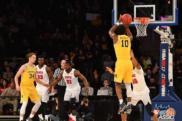 Mark Donnal (34) and Derrick Walton Jr. (10)