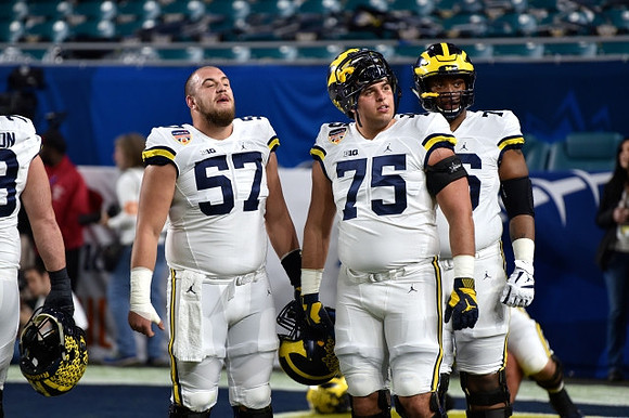 Patrick Kugler (57), Jon Runyan Jr. (75), and Juwann Bushell-Beatty (10)