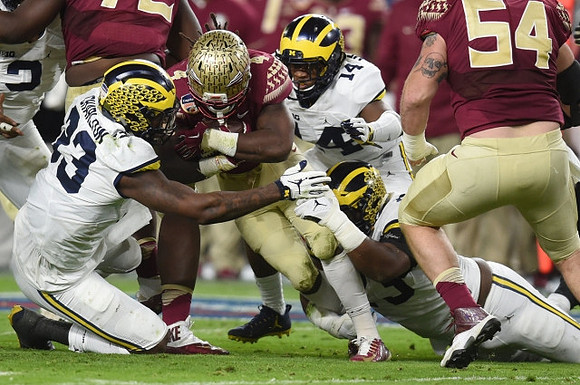 Taco Charlton (33) and Josh Metellus (14)