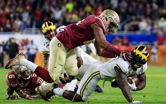 Ben Braden (71) and De'Veon Smith (4)